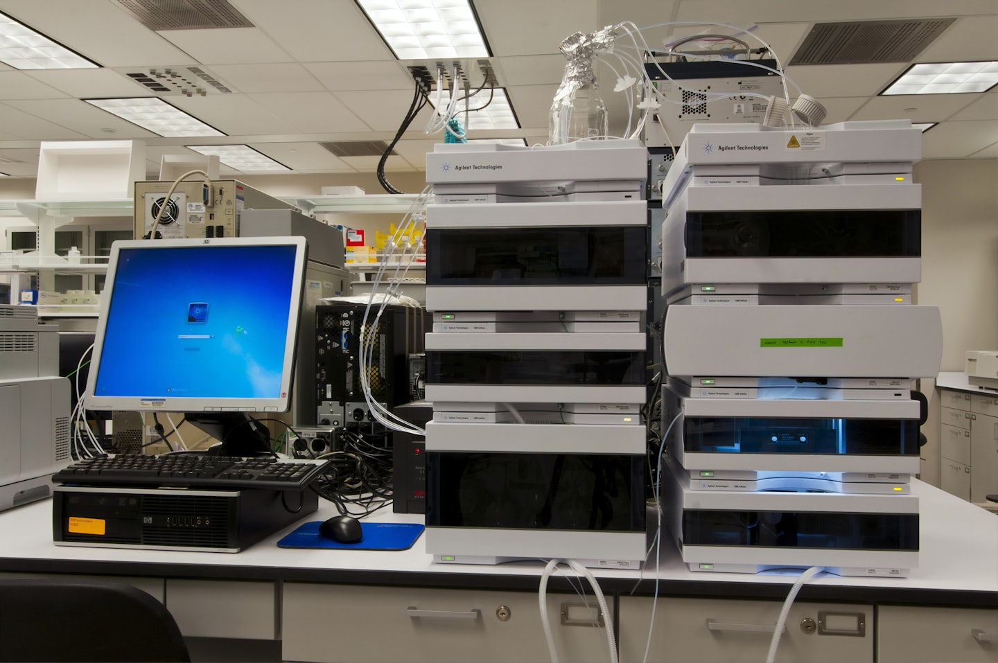 Modern laboratory workstation with scientific instruments and computer.